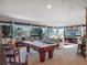 Spacious game room with pool table, comfortable seating, and natural light at 14442 Avenue Of The Rushes, Winter Garden, FL 34787