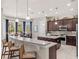 Modern kitchen featuring dark cabinets, stainless steel appliances, and an island at 14442 Avenue Of The Rushes, Winter Garden, FL 34787