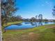 Peaceful lakefront property with lush green grass at 14442 Avenue Of The Rushes, Winter Garden, FL 34787