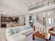 Open living room with high ceilings, kitchen island, and staircase view at 14442 Avenue Of The Rushes, Winter Garden, FL 34787