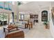 Open living space with high ceilings, kitchen view, and access to backyard at 14442 Avenue Of The Rushes, Winter Garden, FL 34787
