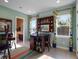 Home office with built-in shelving, desk, and window views at 14442 Avenue Of The Rushes, Winter Garden, FL 34787
