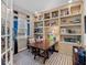 Home office with built-in shelves, a desk, and comfortable seating at 14442 Avenue Of The Rushes, Winter Garden, FL 34787