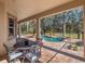 Covered patio with seating area overlooking the pool at 14442 Avenue Of The Rushes, Winter Garden, FL 34787