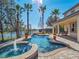 Relaxing pool and spa area with a patio, lake view, and lush landscaping at 14442 Avenue Of The Rushes, Winter Garden, FL 34787