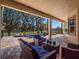 Relaxing covered patio overlooking a refreshing pool and tranquil lake views at 14442 Avenue Of The Rushes, Winter Garden, FL 34787