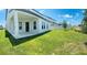 Expansive backyard with lush green grass, a covered patio, and a white fence offering privacy at 16337 Silver Grove Blvd, Winter Garden, FL 34787