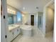 Elegant bathroom with soaking tub, double vanity, and glass shower at 16337 Silver Grove Blvd, Winter Garden, FL 34787