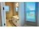 Bright bathroom with white cabinets, tiled floor, and natural light at 16337 Silver Grove Blvd, Winter Garden, FL 34787