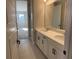 Double vanity bathroom with white cabinets and a large mirror at 16337 Silver Grove Blvd, Winter Garden, FL 34787