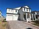 Two-story house with white siding, gray accents, and a two-car garage at 16337 Silver Grove Blvd, Winter Garden, FL 34787