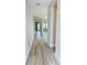 Bright hallway with wood-look flooring and neutral walls at 16337 Silver Grove Blvd, Winter Garden, FL 34787