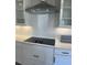 Close-up of the modern kitchen with white subway tile backsplash, quartz countertop, and black electric cooktop at 16337 Silver Grove Blvd, Winter Garden, FL 34787