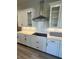 Modern kitchen with white cabinets, quartz countertops, subway tile backsplash, and stainless steel range hood at 16337 Silver Grove Blvd, Winter Garden, FL 34787