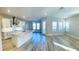 Open floor plan with kitchen island, white cabinets and gray walls at 16337 Silver Grove Blvd, Winter Garden, FL 34787