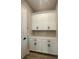 Laundry room with white cabinets and quartz countertops at 16337 Silver Grove Blvd, Winter Garden, FL 34787