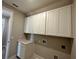 Bright laundry room with upper cabinets and a countertop for folding at 16337 Silver Grove Blvd, Winter Garden, FL 34787