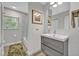 Bright bathroom features a modern vanity, sleek fixtures, recessed lighting, and a shower-tub combo at 1901 Lake Sue Dr, Orlando, FL 32803