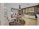 Stylish dining room features a round glass table, unique lighting, and sophisticated decor for intimate gatherings at 1901 Lake Sue Dr, Orlando, FL 32803