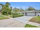 Well-maintained home with a spacious driveway and manicured hedges at 1901 Lake Sue Dr, Orlando, FL 32803