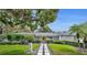 Charming single-story home with mature landscaping and a striking yellow door at 1901 Lake Sue Dr, Orlando, FL 32803
