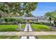 Attractive single-story home with manicured lawn, mature trees, and modern stone pathway leading to the front door at 1901 Lake Sue Dr, Orlando, FL 32803