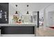 Modern kitchen with sleek white cabinetry, marble countertops, and stainless steel appliances, perfect for culinary enthusiasts at 1901 Lake Sue Dr, Orlando, FL 32803