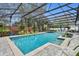 Screened pool features a jacuzzi, lush landscaping, patio furniture, and a beautiful outdoor living space at 1901 Lake Sue Dr, Orlando, FL 32803