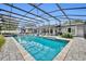 Screened-in in-ground pool with patio furniture and lush landscaping creates a relaxing outdoor living space at 1901 Lake Sue Dr, Orlando, FL 32803