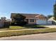 Tan house with a two-car garage and a fenced backyard at 1938 Gamboge Dr, Orlando, FL 32822