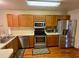 Kitchen with stainless steel appliances and wood cabinets at 1938 Gamboge Dr, Orlando, FL 32822