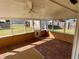 Bright screened porch with brick tile floor and backyard view at 1938 Gamboge Dr, Orlando, FL 32822
