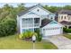 Two-story house with gray siding, teal accents, and a large backyard at 2119 Victoria Dr, Davenport, FL 33837