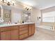 Bathroom boasts double sinks, a soaking tub, and a walk-in shower at 2119 Victoria Dr, Davenport, FL 33837