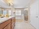 Large bathroom with double vanity, soaking tub, and walk-in shower at 2119 Victoria Dr, Davenport, FL 33837