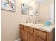 Guest bathroom with single vanity and mirror at 2119 Victoria Dr, Davenport, FL 33837