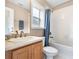 Clean bathroom with tub, shower, and wood vanity at 2119 Victoria Dr, Davenport, FL 33837