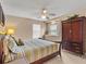 Bedroom with king-size bed, ceiling fan, and a large dresser at 2119 Victoria Dr, Davenport, FL 33837