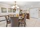 Dining room with glass-top table, chandelier, and adjacent kitchen at 2119 Victoria Dr, Davenport, FL 33837