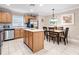 Kitchen boasts light wood cabinets, stainless steel appliances, and an island at 2119 Victoria Dr, Davenport, FL 33837