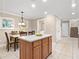 Kitchen island with seating, adjacent dining area, and laundry closet at 2119 Victoria Dr, Davenport, FL 33837