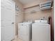 Bright laundry room with washer, dryer, and shelving at 2119 Victoria Dr, Davenport, FL 33837