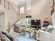 Spacious living room with high ceilings, neutral colors, and a staircase at 2119 Victoria Dr, Davenport, FL 33837