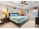 Bright main bedroom with ceiling fan, large bed, and ample natural light at 2119 Victoria Dr, Davenport, FL 33837