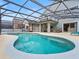 Large kidney shaped pool with screened patio and lounge chairs at 2119 Victoria Dr, Davenport, FL 33837