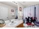 Bathroom with a shower/tub combo, double vanity, and Mickey Mouse decor at 2220 Wyndham Palms Way, Kissimmee, FL 34747