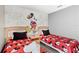 Mickey Mouse themed bedroom with twin beds, nightstand, and themed bedding at 2220 Wyndham Palms Way, Kissimmee, FL 34747