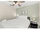 Bedroom with queen-size bed, nightstand, and ceiling fan at 2220 Wyndham Palms Way, Kissimmee, FL 34747