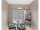 Cozy breakfast nook with glass table and four chairs at 2220 Wyndham Palms Way, Kissimmee, FL 34747
