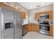 Kitchen boasts stainless steel appliances and wood cabinets at 2220 Wyndham Palms Way, Kissimmee, FL 34747